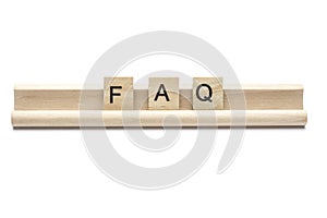 Abbreviation of FAQ on scrabble wooden letters on a rack