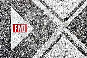 The abbreviation forward fwd written on asphalt road with direction arrows. Moving forward photo