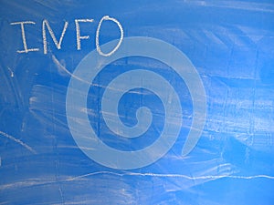 Abbreviation INFO written on a blue, relatively dirty chalkboard by chalk. Located in the upper left corner of the image making