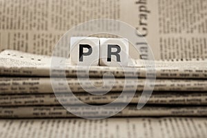 Abbreviation PR on newspapers