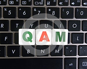 Abbreviation QAM on keyboard background photo