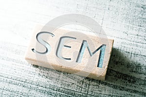 Abbreviation SEM Engraved On A Wooden Block On A Table