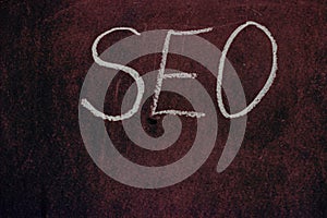 The abbreviation `SEO` on a vintage burgundy background