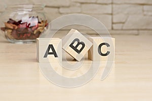 ABC - acronym from wooden blocks with letters, top view on grey background