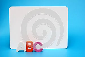 ABC - the letters of the English alphabet near the white Board. Concept of education