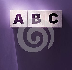 ABC letters wooden blocks on purple. Education concept