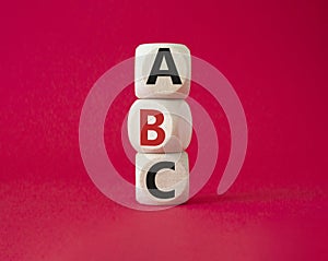 ABC symbol. Concept word ABC on wooden blocks. Beautiful red background. Business and ABC concept. Copy space