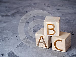 ABC text on wooden blocks on gray concrete background
