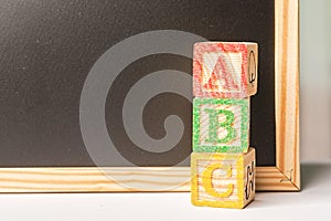 ABC Wooden blocks against chalkboard