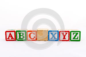 ABC and XYZ alphabet wooden blocks isolated on white background photo