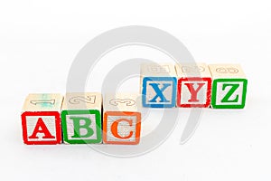 ABC and XYZ wooden alphabet blocks isolated on white background photo