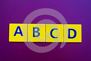 ABCD spelling on yellow plastic cubes