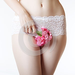 Abdomen and thighs with a bunch of flowers photo