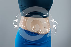 Abdominal fat problems, massaging marks. Healthy lifestyle and sports activities concept photo
