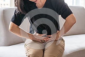 Abdominal pain in woman with stomachache illness from menstruation cramps, stomach cancer, irritable bowel syndrome