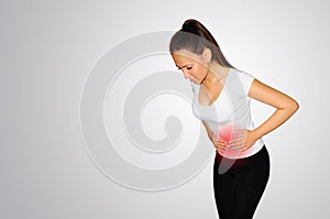 Abdominal pain. A young woman suffers from pain in the abdomen. The problem with digestion. The problem of women`s health, the co