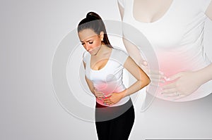 Abdominal pain. A young woman suffers from pain in the abdomen. The problem with digestion. The problem of women`s health, the co