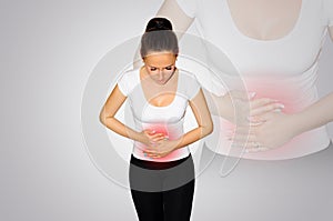 Abdominal pain. A young woman suffers from pain in the abdomen. The problem with digestion. The problem of women`s health, the co