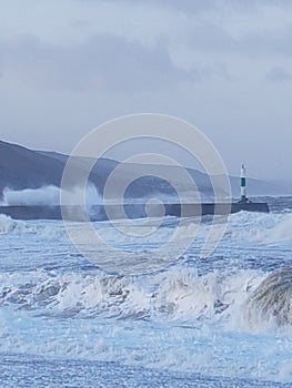 Aberystwyth Lighthouse during storm ciara, rough seas.