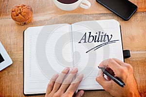 Ability against man writing notes on diary