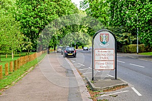 Abington park entrance sign between footpath and road in northampton england uk photo