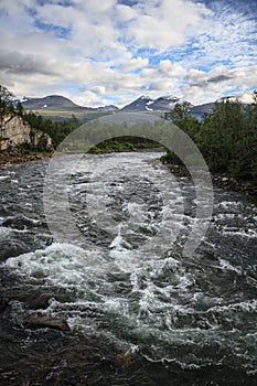 Abiskojaure river flowing through Abisko National Park in Lapland, Sweden