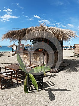 Abkhazia, Gagra 05.09.2021. Bar gazebo in tropical style made of bamboo and with a thatched roof on the beach of small