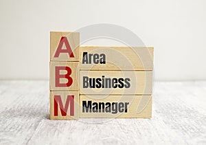 ABM area business manager symbol. Concept words ABM area business manager on wooden blocks