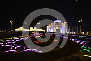 ABNight view of Presidential Palace gate and colorful fountains in Abu Dhabi,