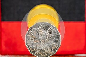 Aboriginal flag with 50 Australian cents coin, Concept, situation of the indigenous people of Australia