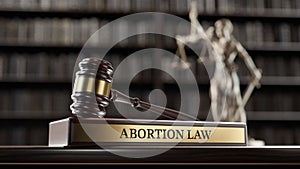 Abortion law: Judge's Gavel as a symbol of legal system, Themis is the goddess of justice and wooden stand with text photo