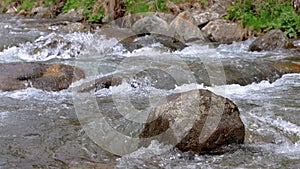 Abounding river detail with close up of rock, in Spanish Pyrenees mountains