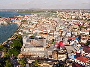 Above the Building Roofs Aerial view of Zanzibar, Stone Town. Tanzania. Sunset Time Coastal City in Africa