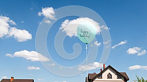 Above buildings. Roofs of houses. Air balloon on the background of the sky. Rise to the sky. Light, weightless. Holiday concept. photo
