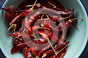 Above, chilli and bowl on closeup for pepper or spice for flavor and dry ingredient for cooking, cuisine and food