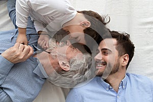 Above close up view laughing three generations of men family