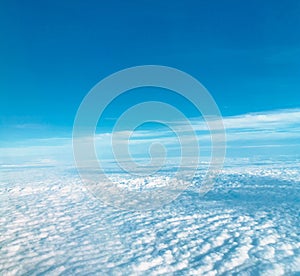 Above the clouds and blue sky.