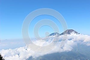 Above the clouds, the top of the mountain