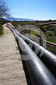 Above ground pipeline recedes in the distance photo