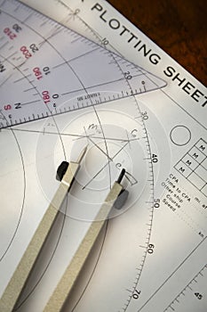 Above image of a navigator's radar plotting chart with a triangle and compass divider
