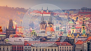 Above medieval Prague old town towers and domes at evening, Czech