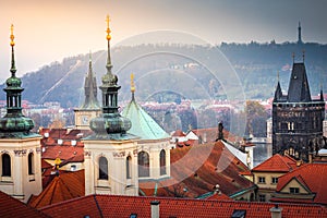 Above medieval Prague old town towers and domes at evening, Czech