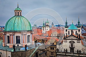 Above medieval Prague old town towers and domes at evening, Czech