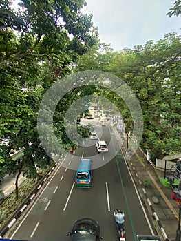 Above the road crossing there are cool motorbikes and trees