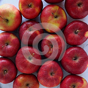 From above shot of tasty red apples flat lay. Gyration red ripe apples close-up.