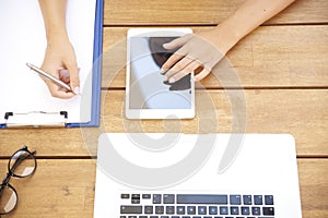 From above shot of woman`s hand touching digital tablet and writ