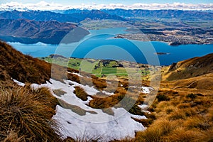 Above the snow line on Roys Peak looking down to Lake Wanaka and the town of Wanaka