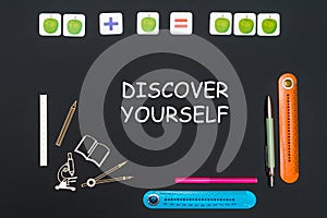 Above stationery supplies and text discover yourself on blackboard