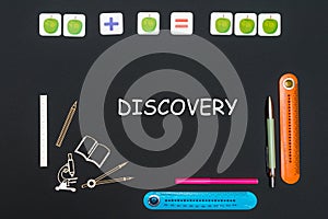 Above stationery supplies and text discovery on blackboard