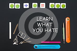 Above stationery supplies and text learn what you hate on blackboard